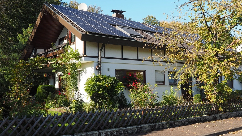 Klasična podeželska hiša s solarnimi paneli na strehi.