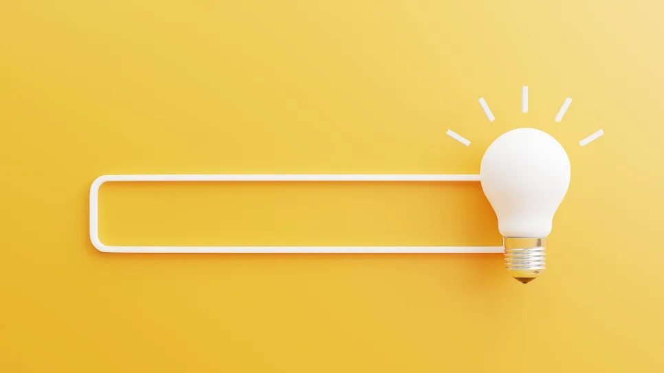 Narisano iskalniško polje na rumeni podlagi, z žarnico.