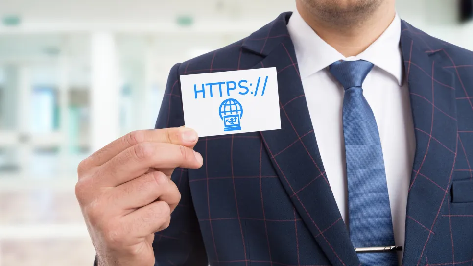 moški drži v rokah vizirko na kateri je napisano https