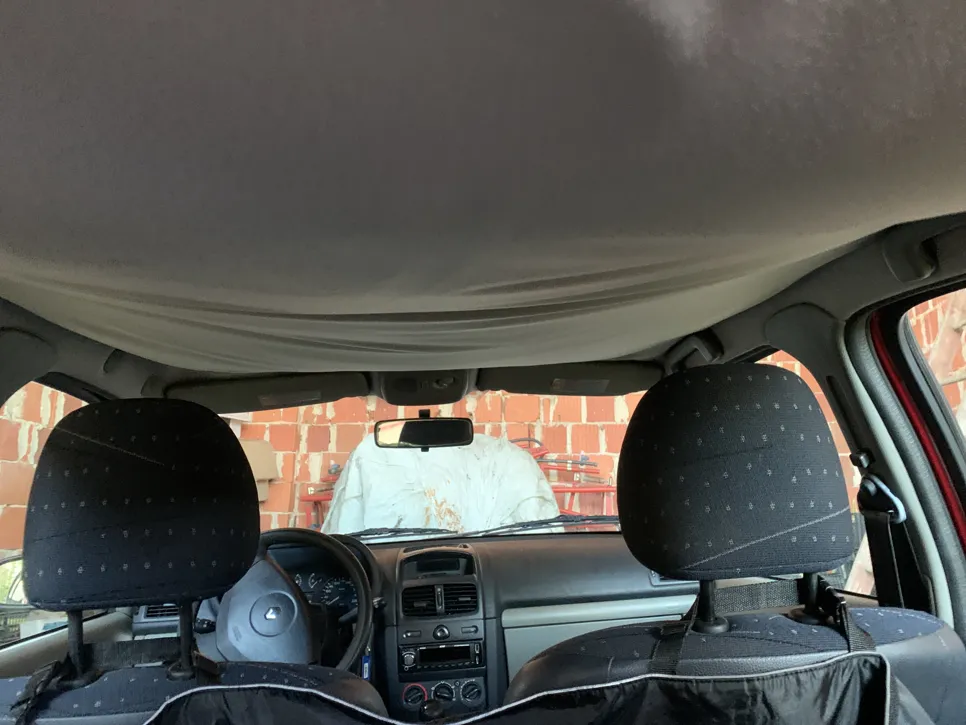 Sagging car headliner causing interior discomfort and potential obstruction in vehicle. Common issue in older cars.