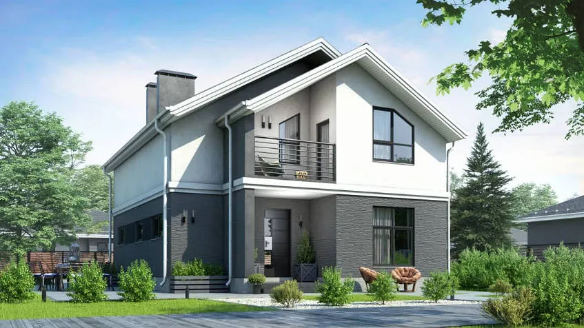 Velika hiša s sivim spodnjim delom in belim zgornjim delom fasade.